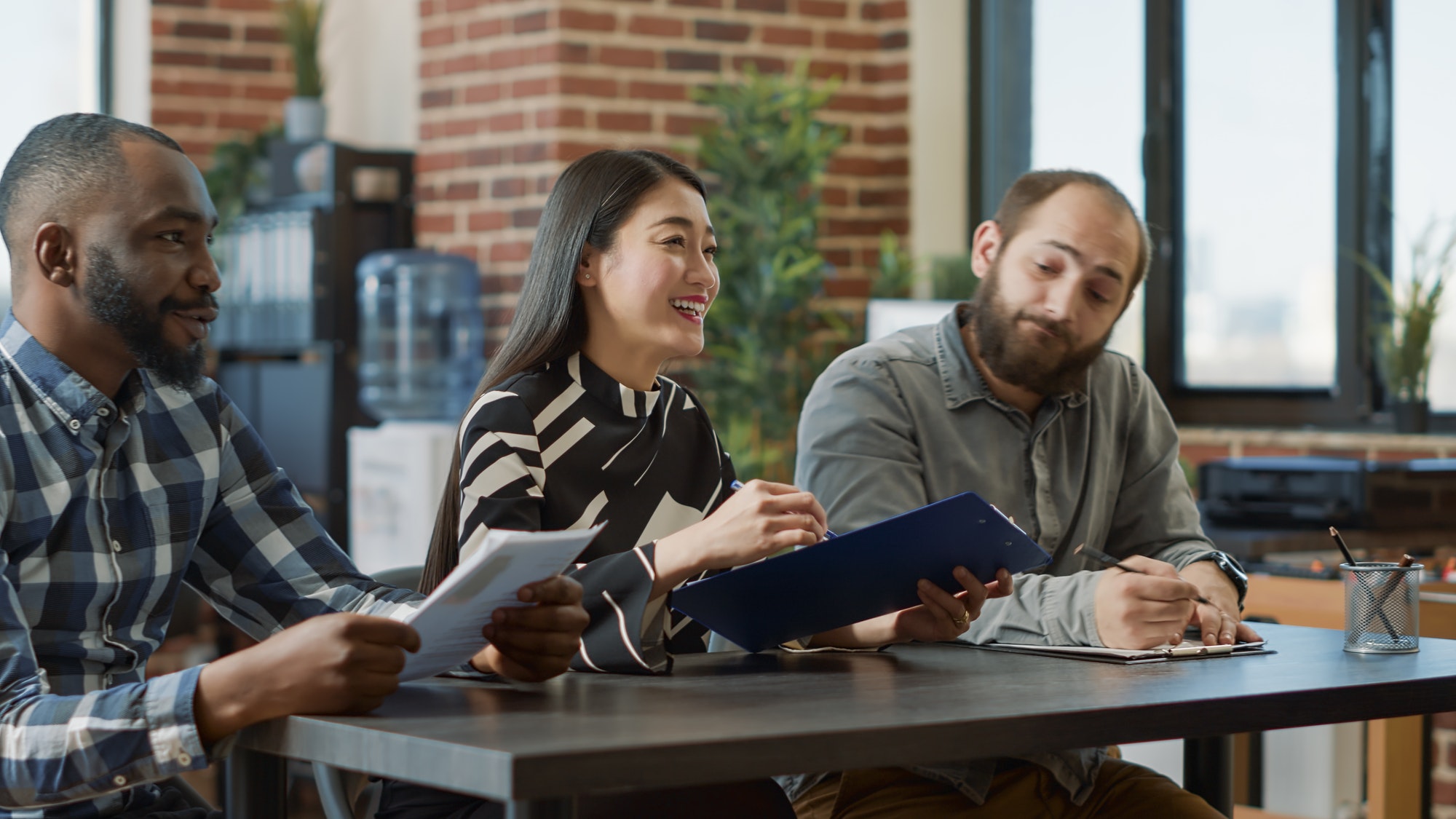 Multiethnic group of recruiters interviewing confident woman